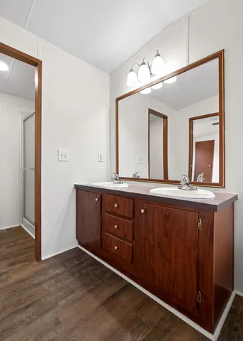 a bathroom with a double vanity sink and a mirror