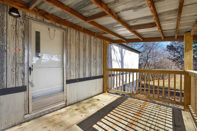 a view of a street with wooden fence