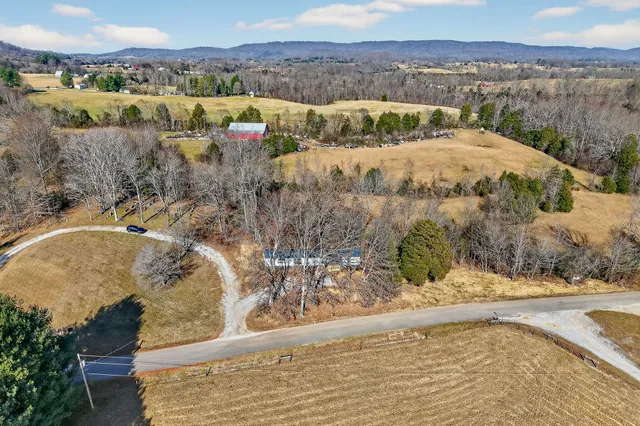 a view of a house with a yard and sitting area