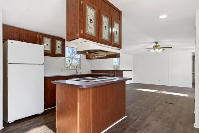 a kitchen with stainless steel appliances granite countertop a stove a refrigerator and a microwave