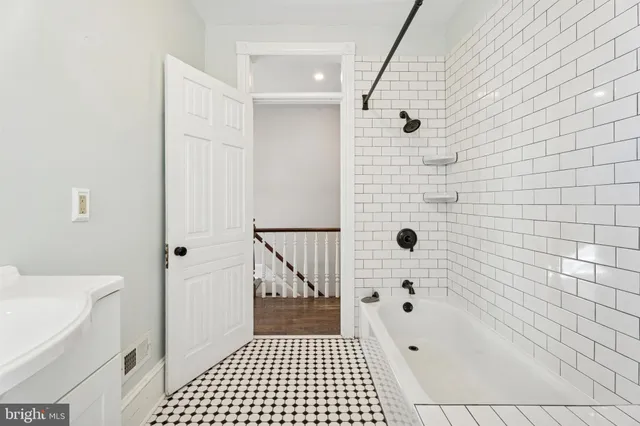 a bathroom with a bathtub and shower