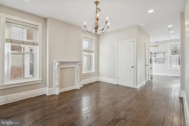 a view of livingroom with chandelier and wooden floor