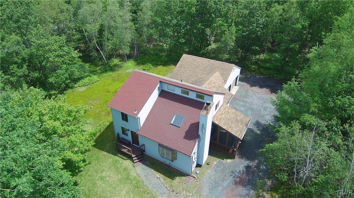 an aerial view of a house with a yard