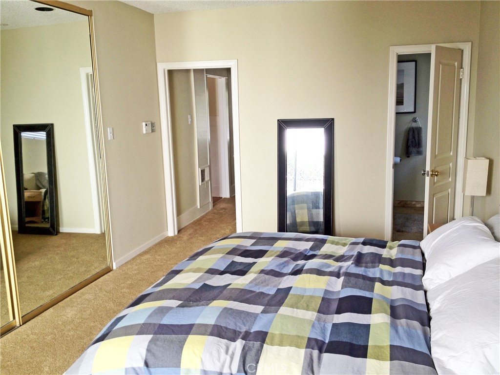 308 Coronado Avenue Long Beach, CA 90814 - Photo 3 of 10 a bedroom with a bed and a mirror