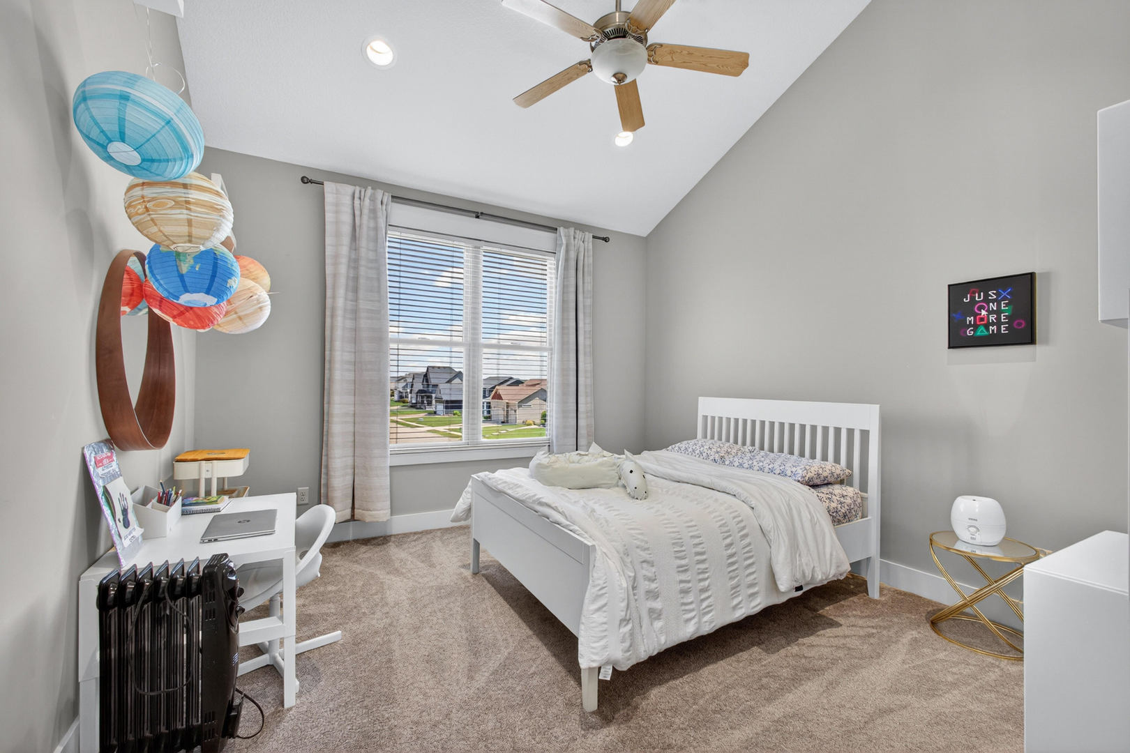 5700 Emily Road Bettendorf, IA 52722 - Photo 22 of 58 a bedroom with a bed and a chandelier