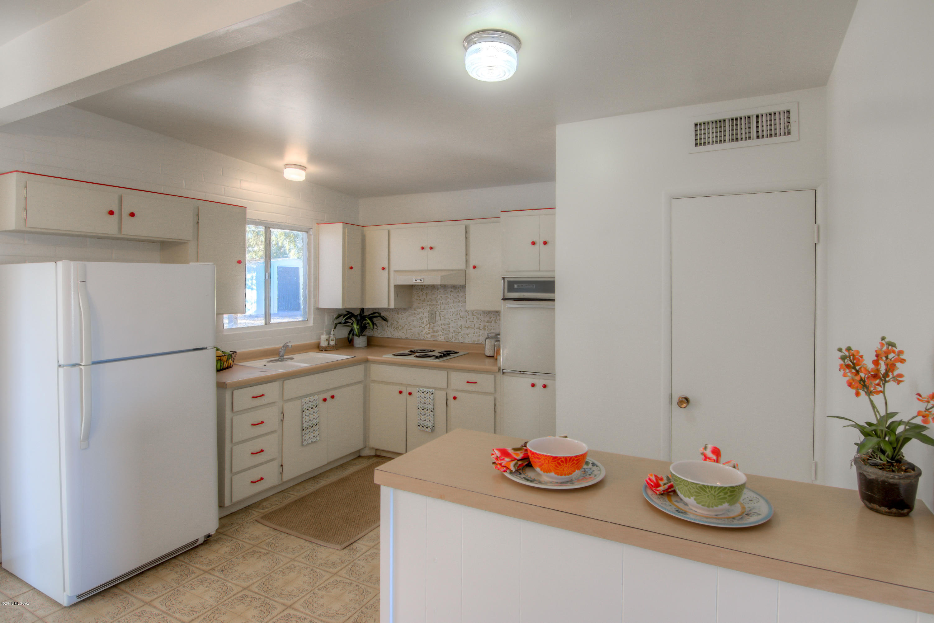 1841 West Astolat Road Tucson, AZ 85713 - Photo 2 of 40 a kitchen with white cabinets and white appliances