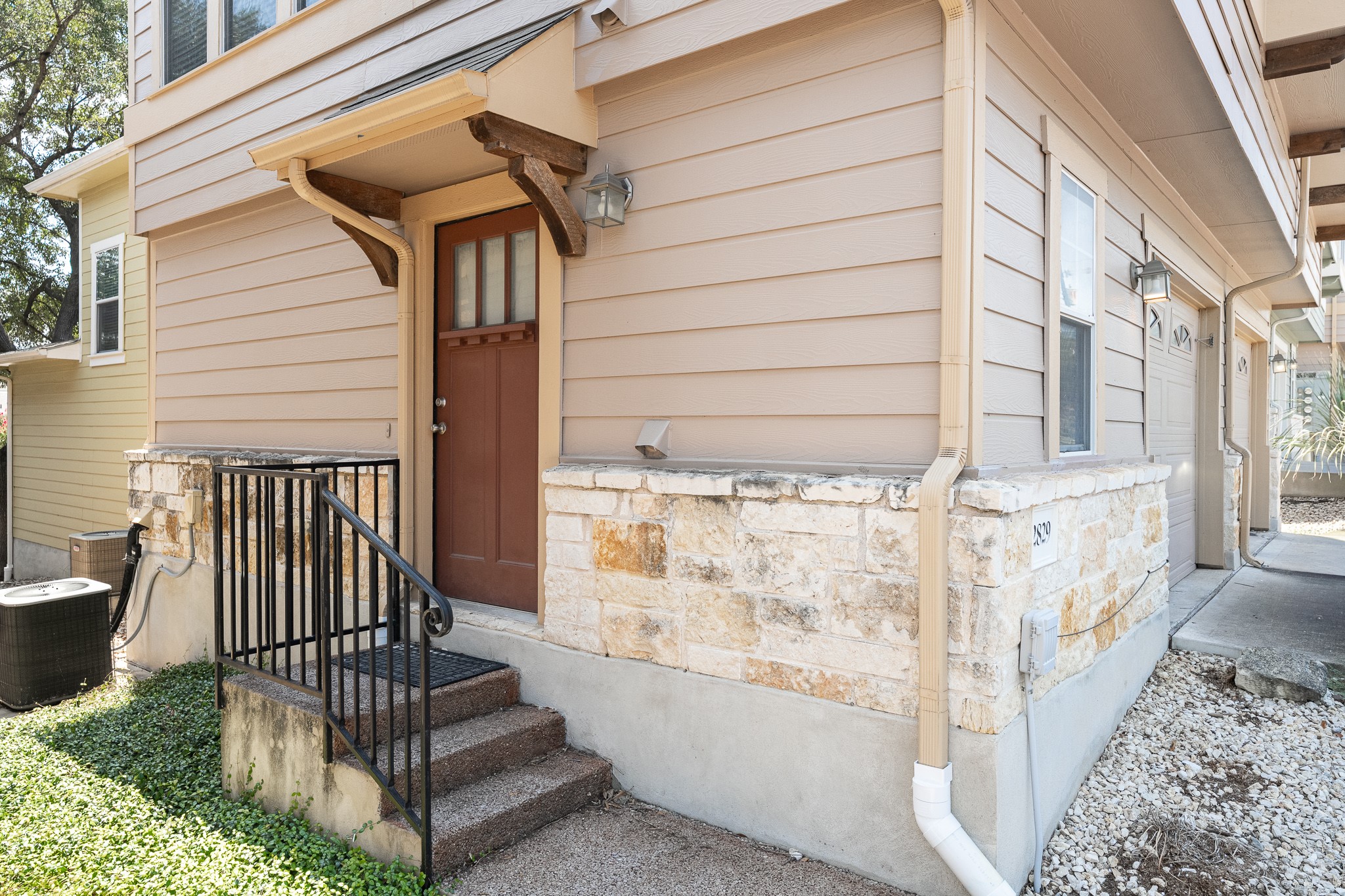 2829 Saville Loop, Unit 17C Austin, TX 78741 - Photo 26 of 28 A welcoming entry, with a classic wood door and complementary stone detailing, defines this home's inviting facade.