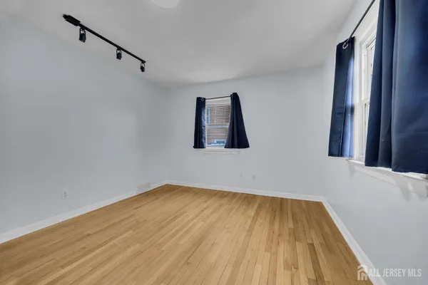 a view of room with window and wooden floor