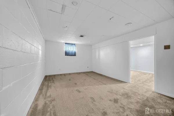 an empty room with a empty space and windows