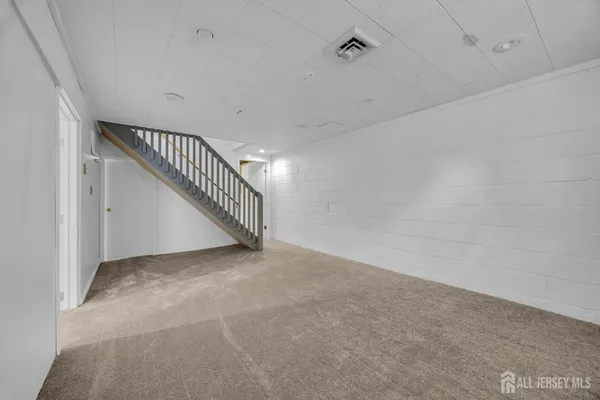 a view of an empty room with stairs