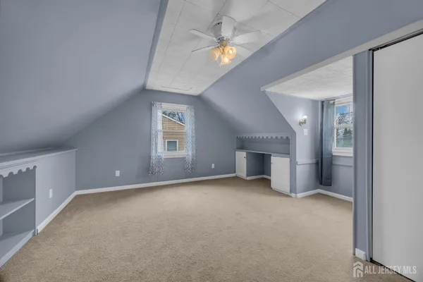 an empty room with a empty space and a ceiling fan