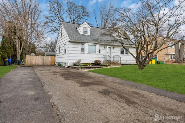 a view of a house with a yard with a large tree