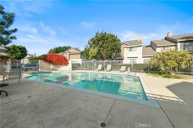 a view of backyard with swimming pool and outdoor seating
