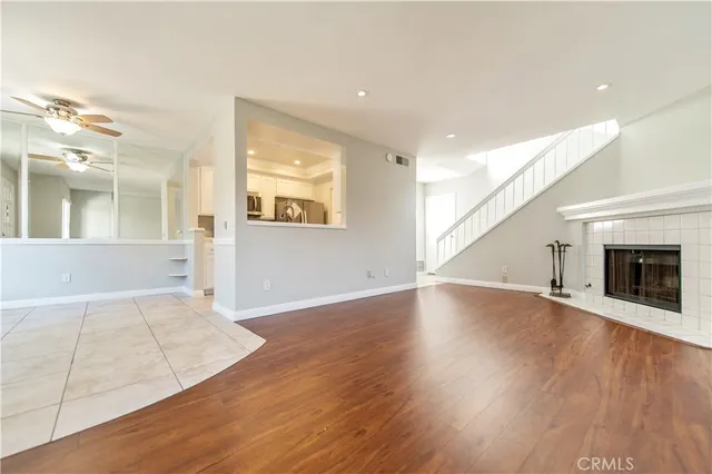 an empty room with wooden floor and fireplace