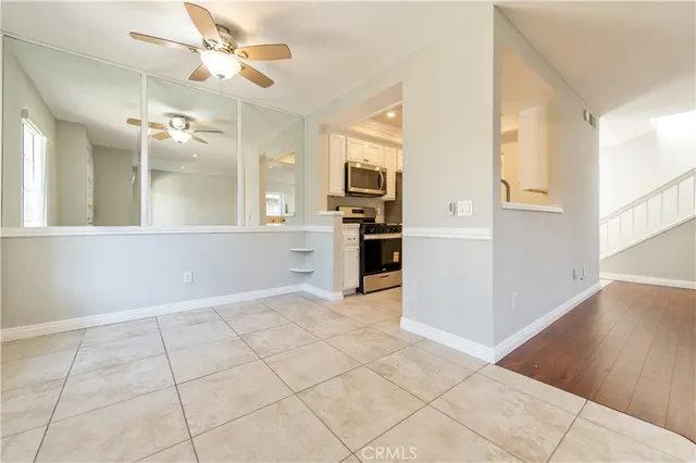 a kitchen with granite countertop a refrigerator and a stove top oven