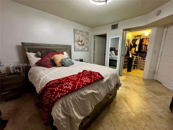 a bedroom with a large bed and a walk in closet