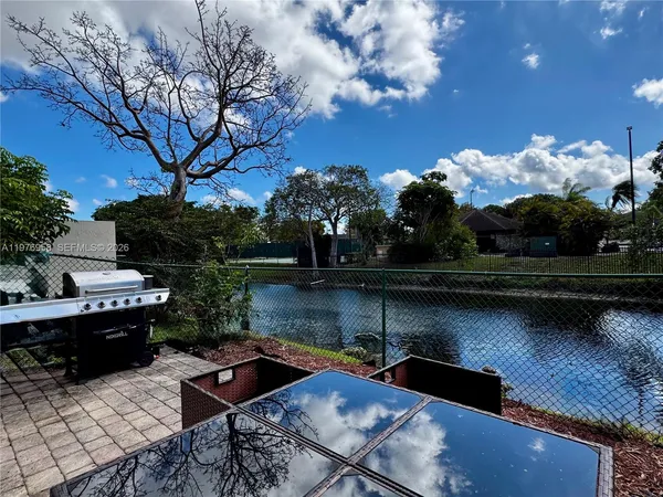 a view of a lake with couches and wooden floor