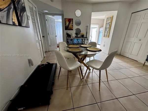 a living room with furniture and a mirror