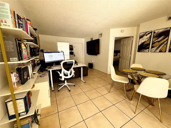 a work room with furniture and a flat screen tv