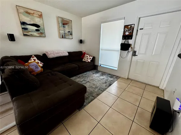 a living room with furniture and a rug