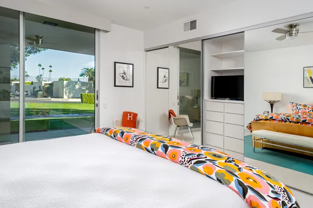 a bed room with a bed and a flat screen tv