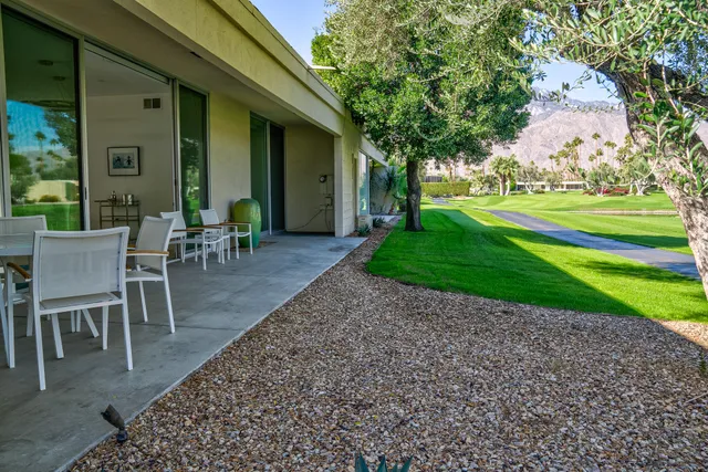a view of a house with backyard porch and sitting area