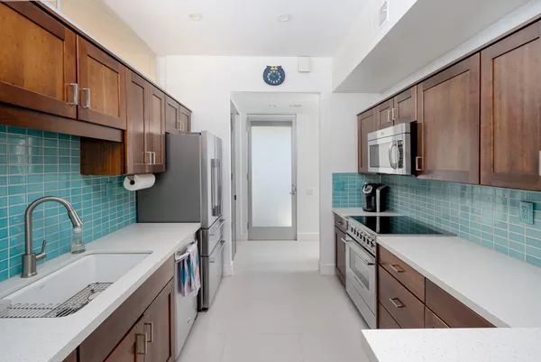 a kitchen with a sink stove and refrigerator