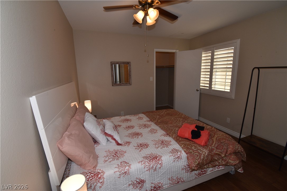 267 Westwind Road Henderson, NV 89074 - Photo 20 of 27 A comforting bedroom with a ceiling fan, a window, and a convenient closet.