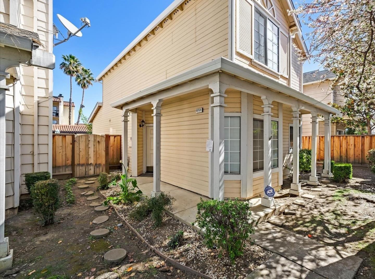 a view of a house with a small yard and plants