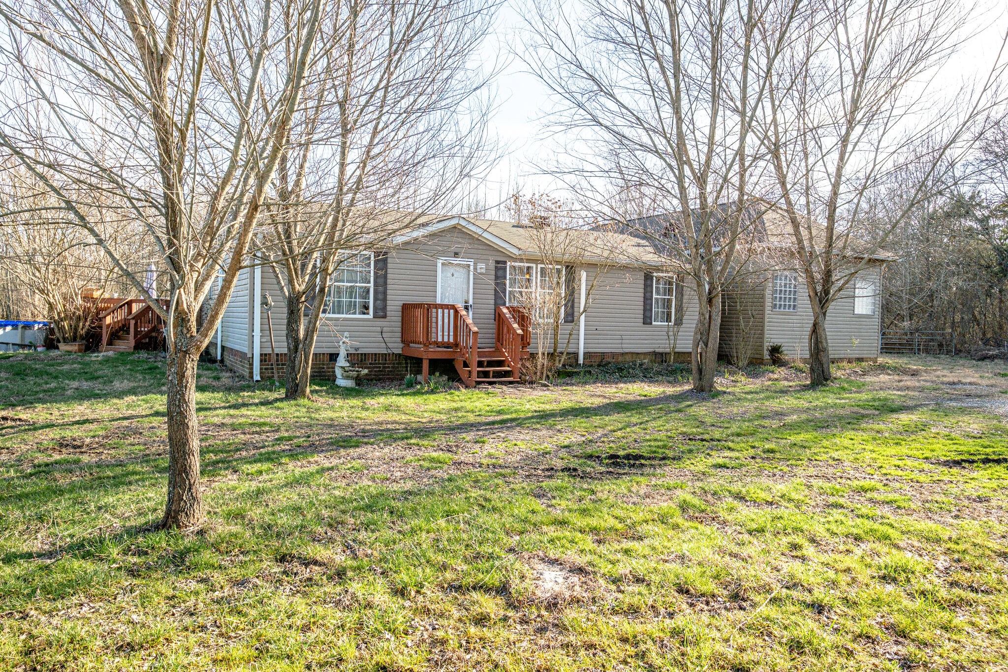 a view of a house with a yard covered in snow