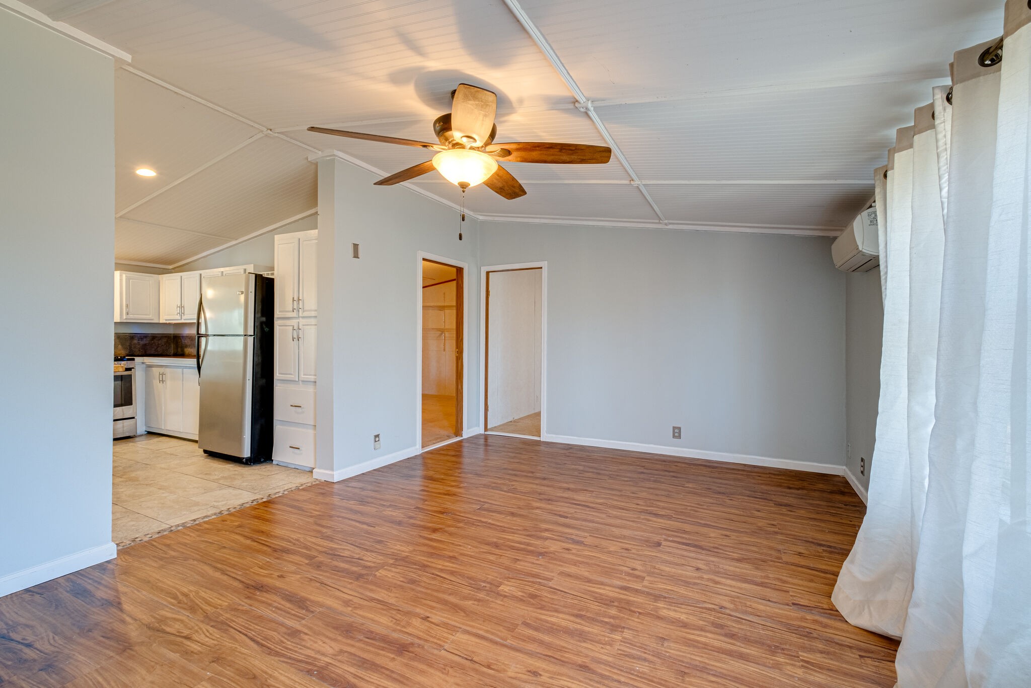 576 Swamp Road Eagleville, TN 37060 - Photo 5 of 27 a view of an empty room with wooden floor and a ceiling fan