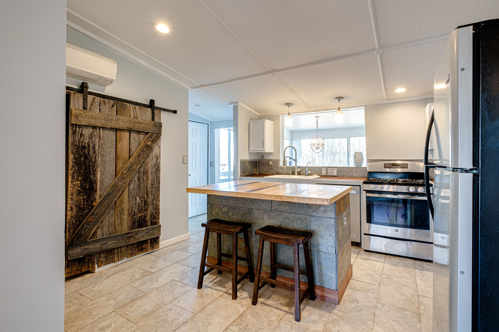 576 Swamp Road Eagleville, TN 37060 - Photo 6 of 27 a kitchen with a table chairs refrigerator and microwave