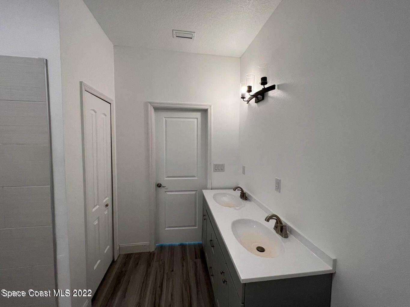2498 Mitchell Avenue Mims, FL 32754 - Photo 11 of 18 a bathroom with a sink and mirror