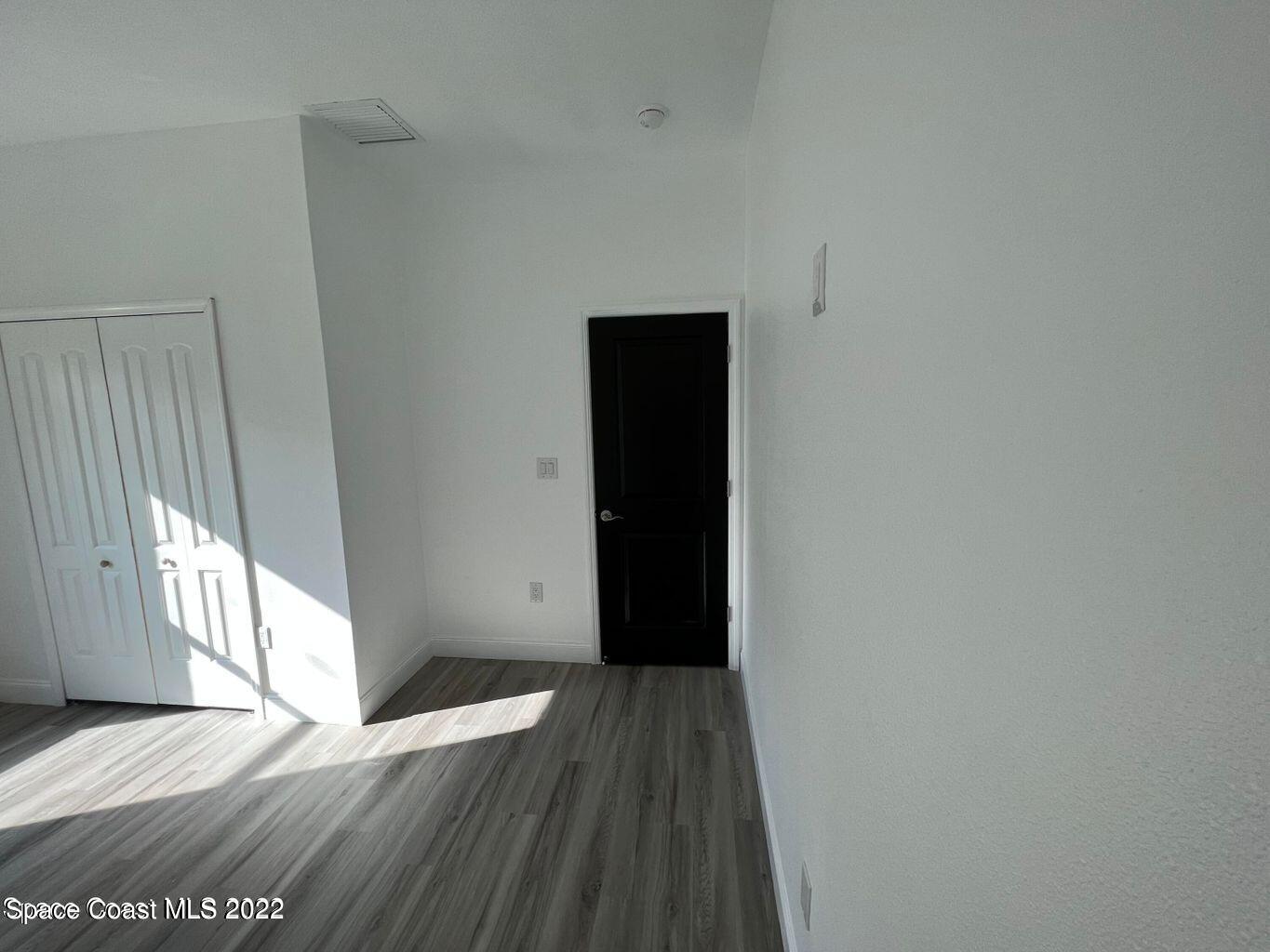 2498 Mitchell Avenue Mims, FL 32754 - Photo 12 of 18 a view of a hallway with wooden floor