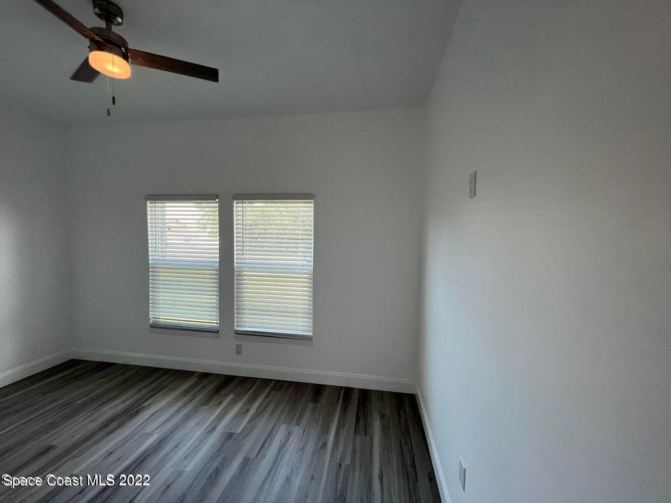 2498 Mitchell Avenue Mims, FL 32754 - Photo 14 of 18 an empty room with wooden floor and windows