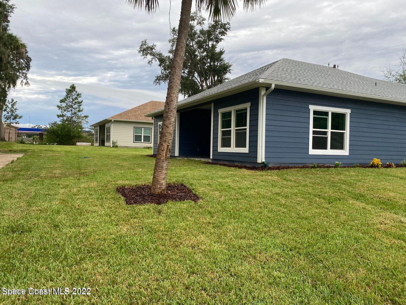 2498 Mitchell Avenue Mims, FL 32754 - Photo 16 of 18 a front view of a house with a garden