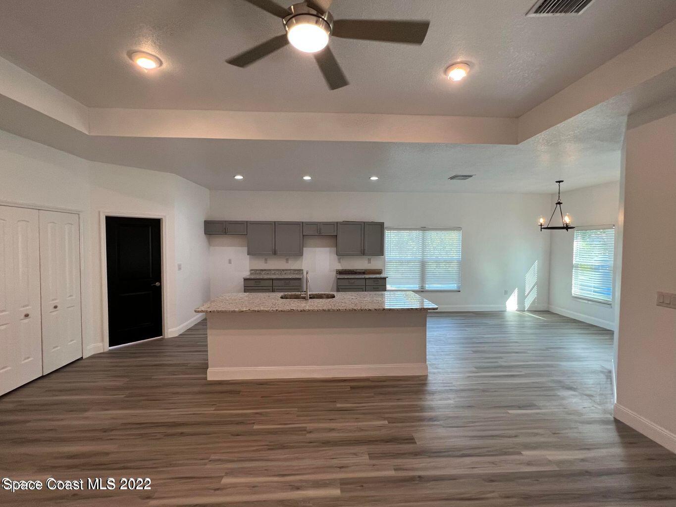 2498 Mitchell Avenue Mims, FL 32754 - Photo 6 of 18 a view of kitchen with cabinets and wooden floor