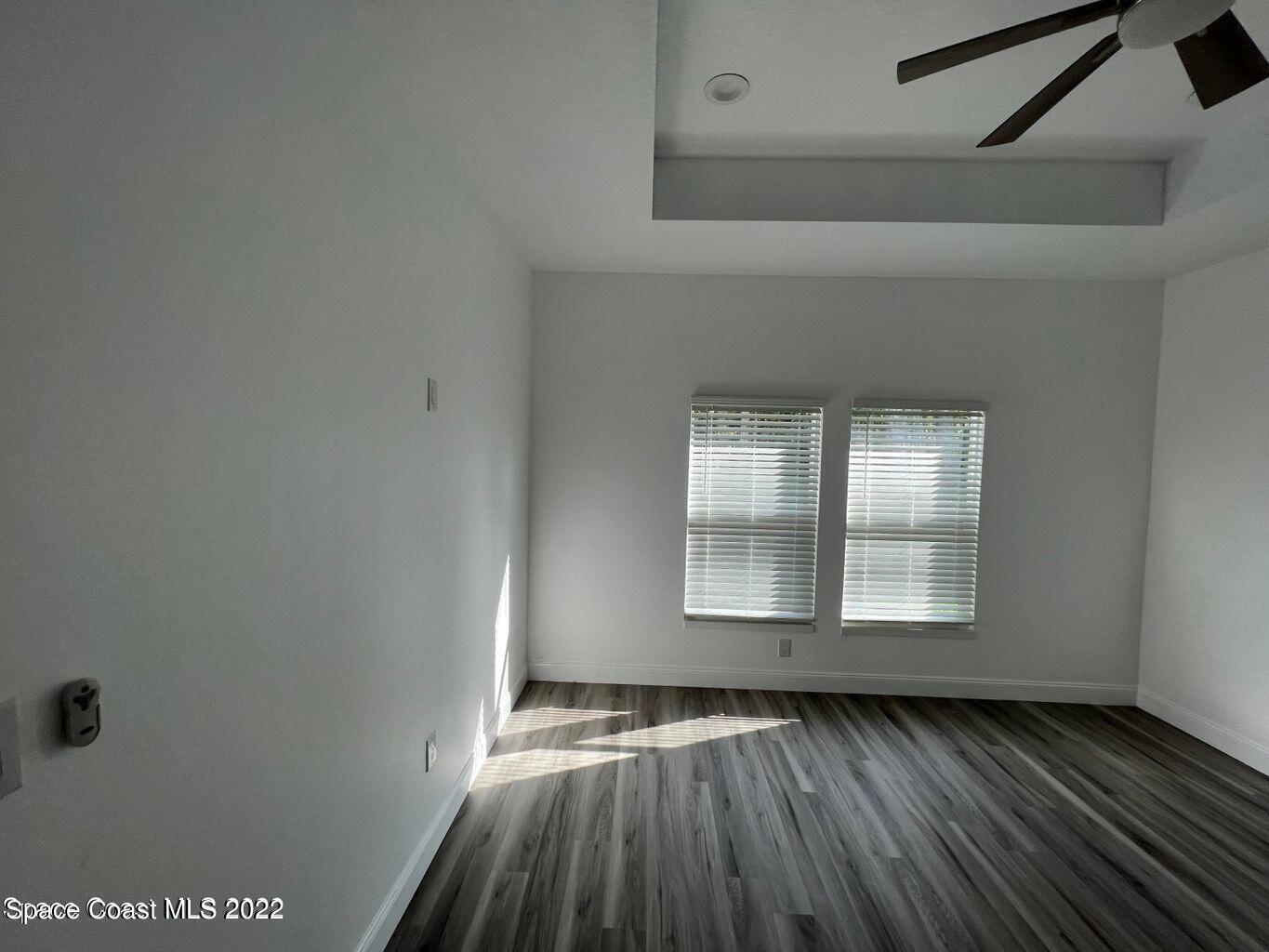2498 Mitchell Avenue Mims, FL 32754 - Photo 8 of 18 an empty room with wooden floor and windows
