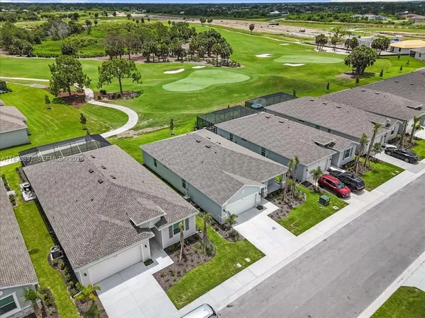 an aerial view of a house with garden space and street view