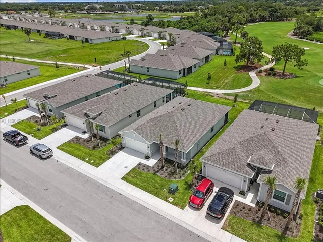 an aerial view of a house with garden space and street view