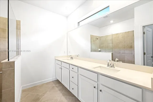 a bathroom with a double vanity sink and mirror