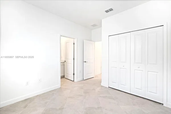 a bathroom with a granite countertop bathtub shower sink vanity mirror and toilet