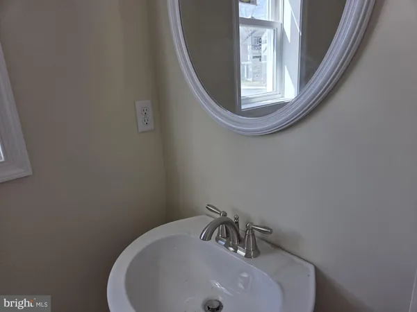 a white toilet sitting next to a white cabinet