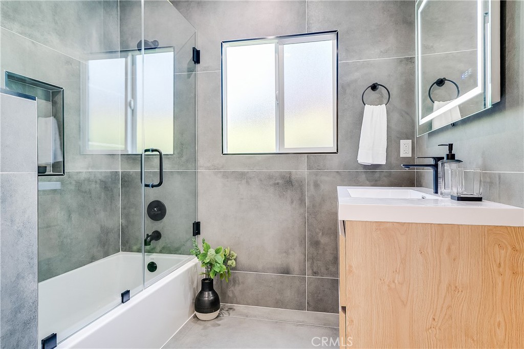 775 Morada Place Altadena, CA 91001 - Photo 11 of 32 a bathroom with a tub a sink and a large mirror