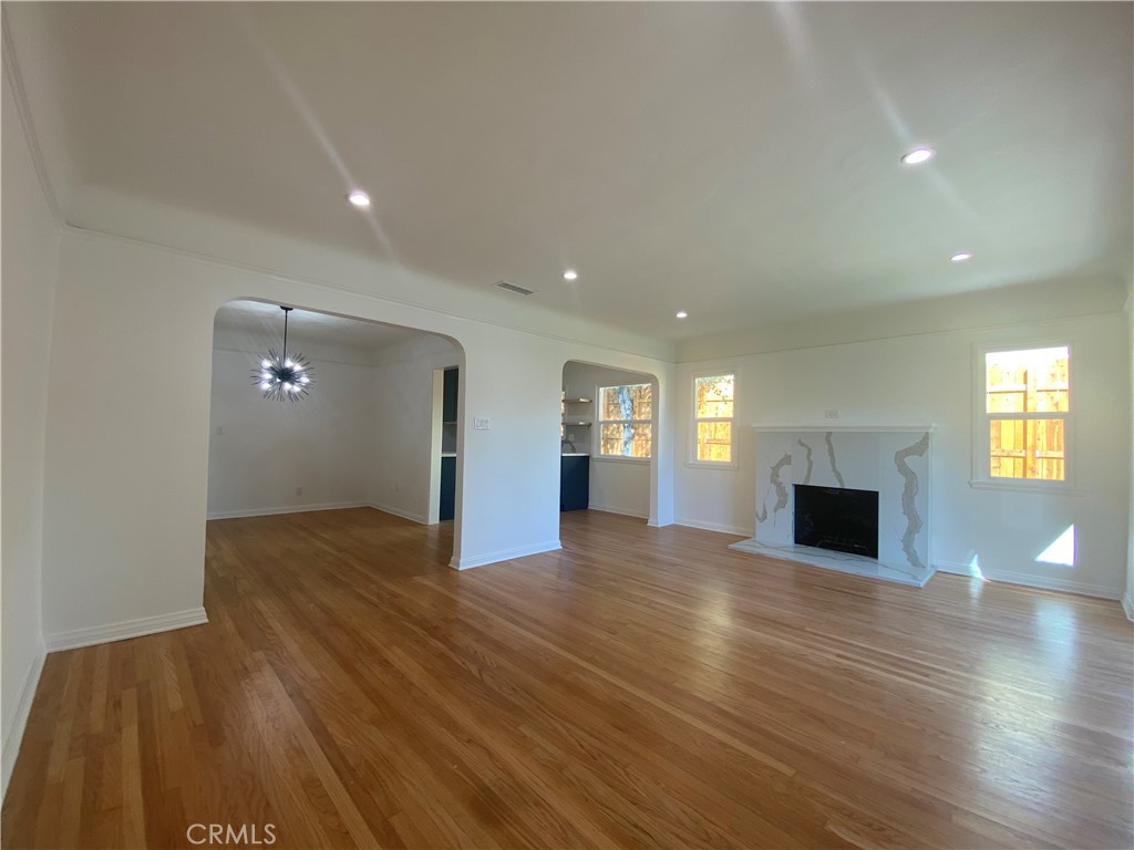 775 Morada Place Altadena, CA 91001 - Photo 14 of 32 a view of a livingroom with wooden floor and fireplace