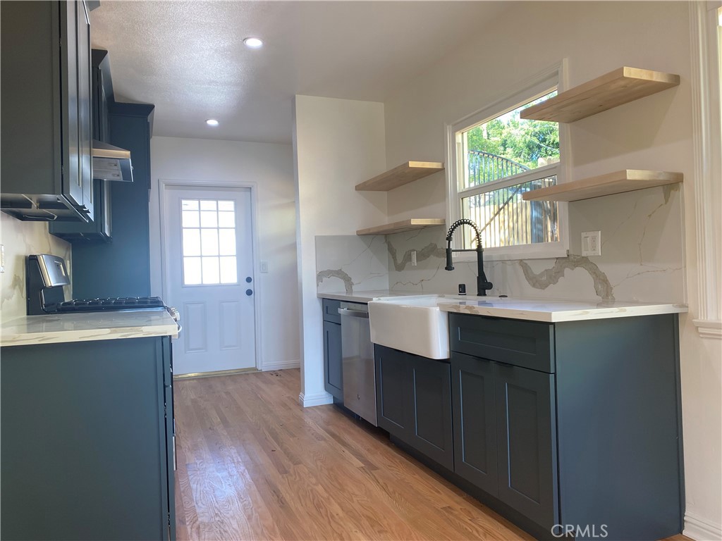 775 Morada Place Altadena, CA 91001 - Photo 15 of 32 a kitchen with stainless steel appliances granite countertop a sink stove and cabinets