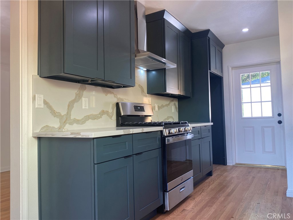 775 Morada Place Altadena, CA 91001 - Photo 16 of 32 a kitchen with stainless steel appliances granite countertop a sink stove and cabinets