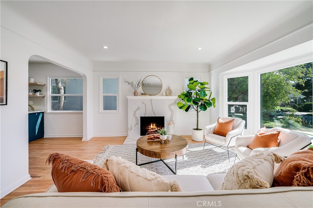 775 Morada Place Altadena, CA 91001 - Photo 2 of 32 a living room with furniture a fireplace and a floor to ceiling window