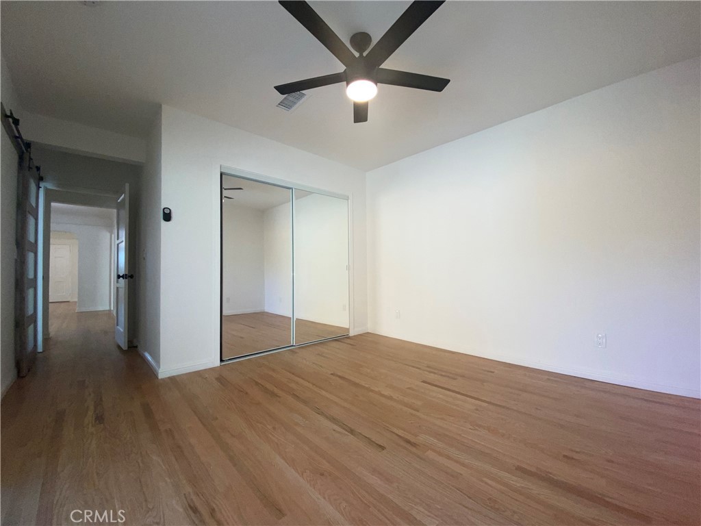 775 Morada Place Altadena, CA 91001 - Photo 27 of 32 a view of a big room with wooden floor and a chandelier fan