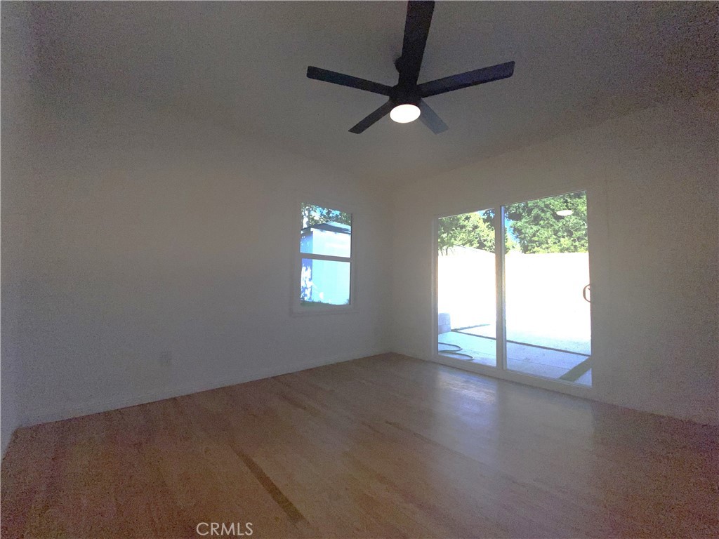 775 Morada Place Altadena, CA 91001 - Photo 28 of 32 an empty room with wooden floor fan and windows